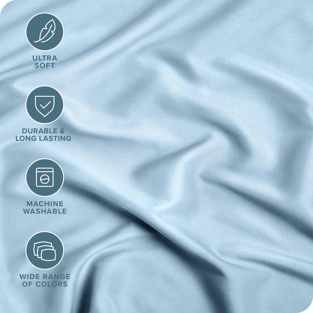 Light blue fitted sheet fabric close-up with smooth, draped texture