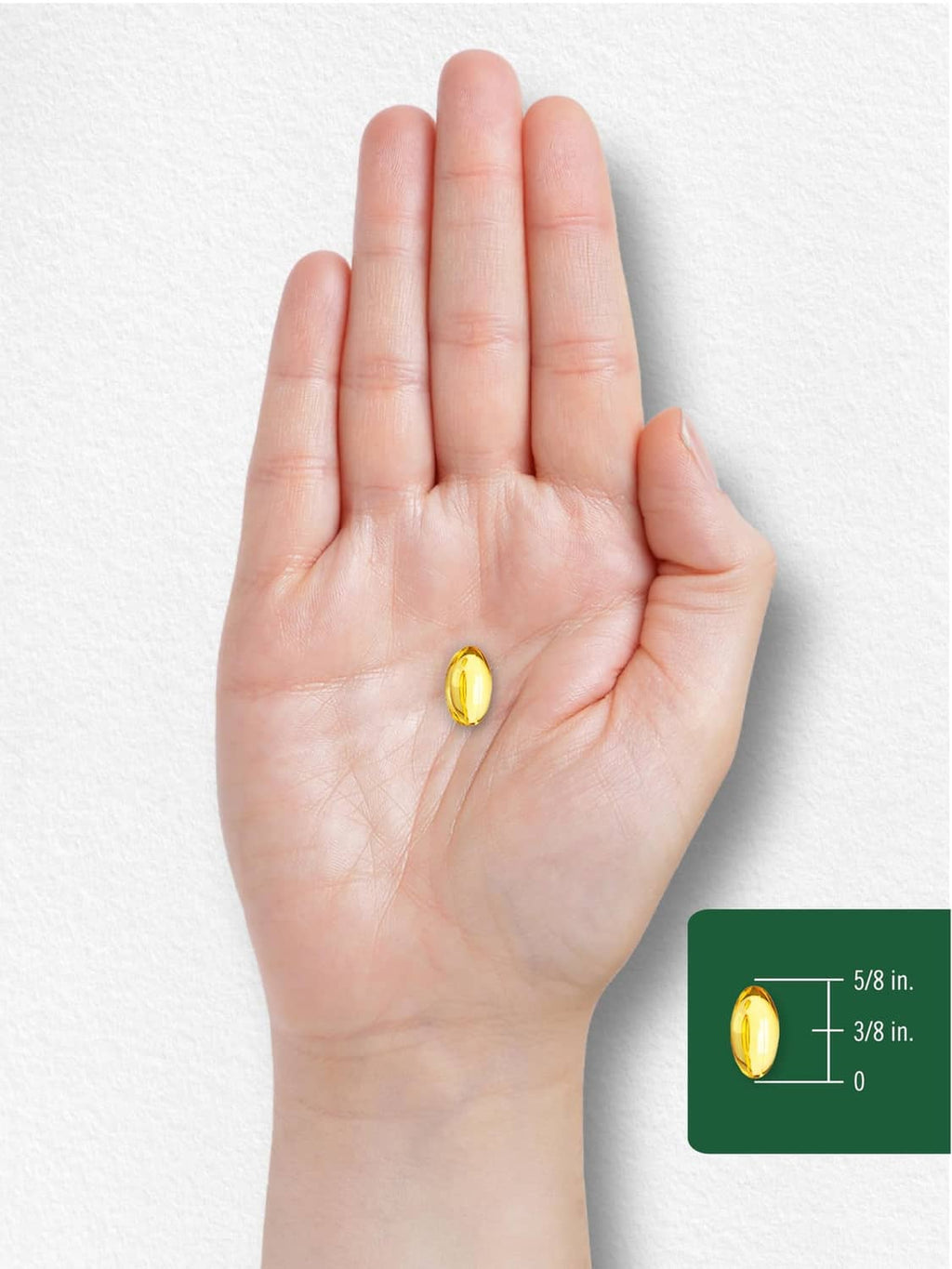 Hand holding a yellow softgel with size markings for oregano oil supplement
