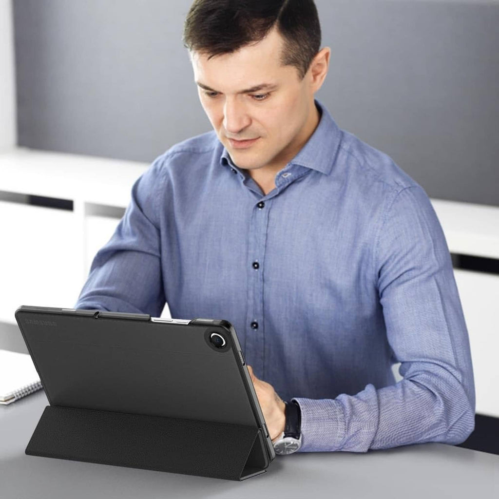 Black tablet case with kickstand propping tablet while in use on a desk