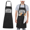 Black adjustable kitchen apron with pocket and “STAND BACK DADDY IS COOKING” print
