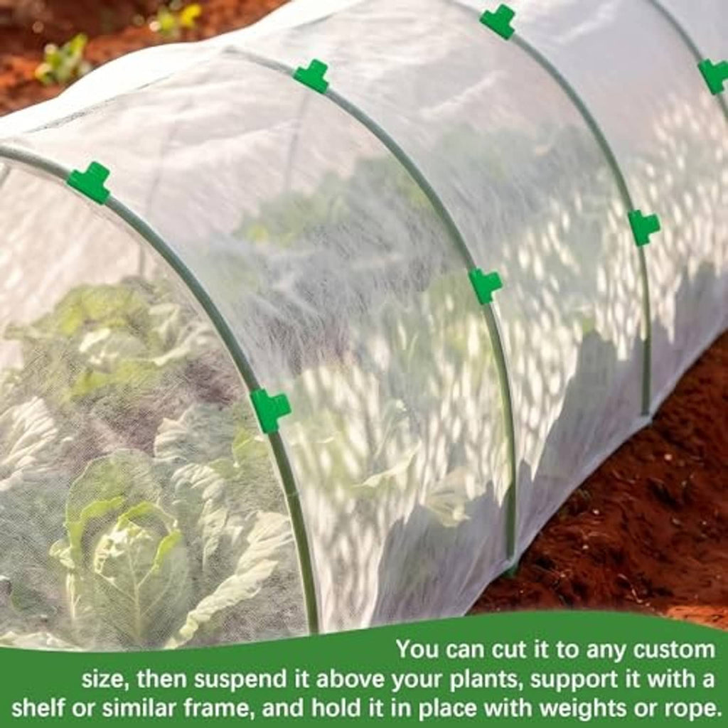 White non-woven tunnel cover with green clips over soil, close-up for custom fit.