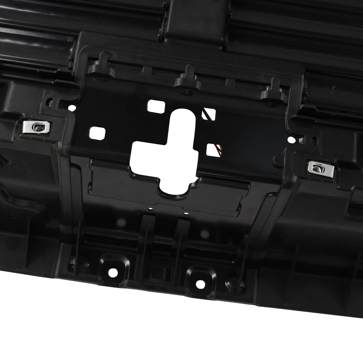Black grille shutter module with mounting cutouts and central actuator opening