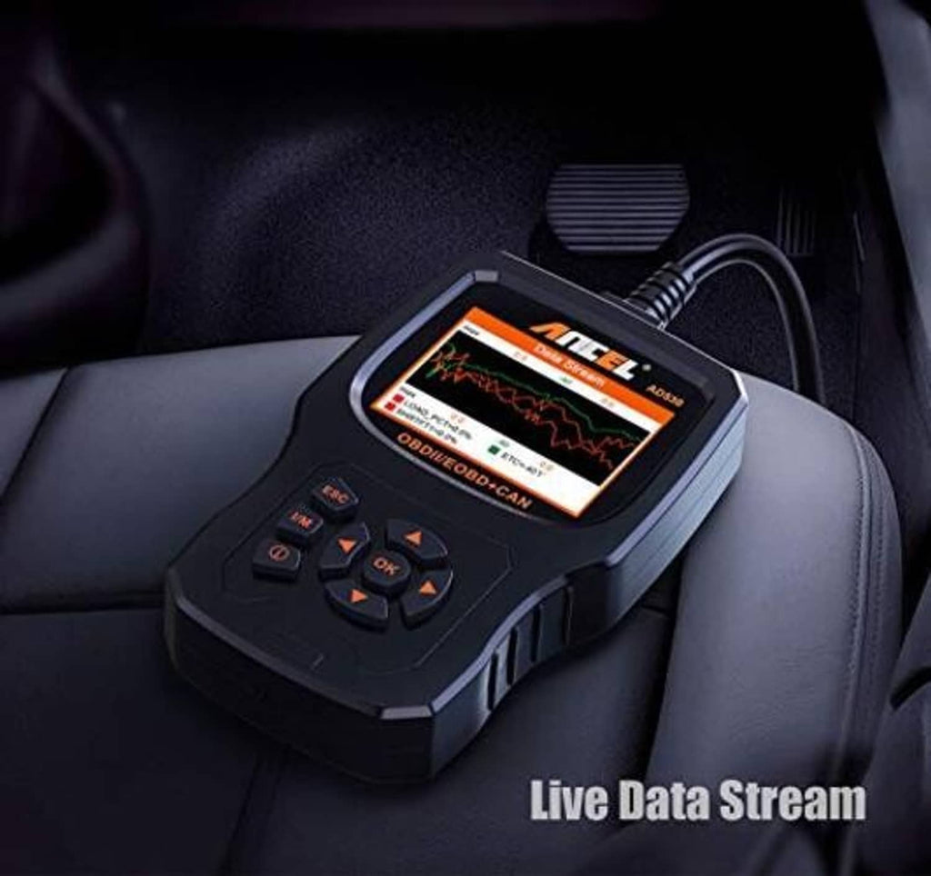 OBD2 scanner resting on a seat with live data screen and OBDII connector cable
