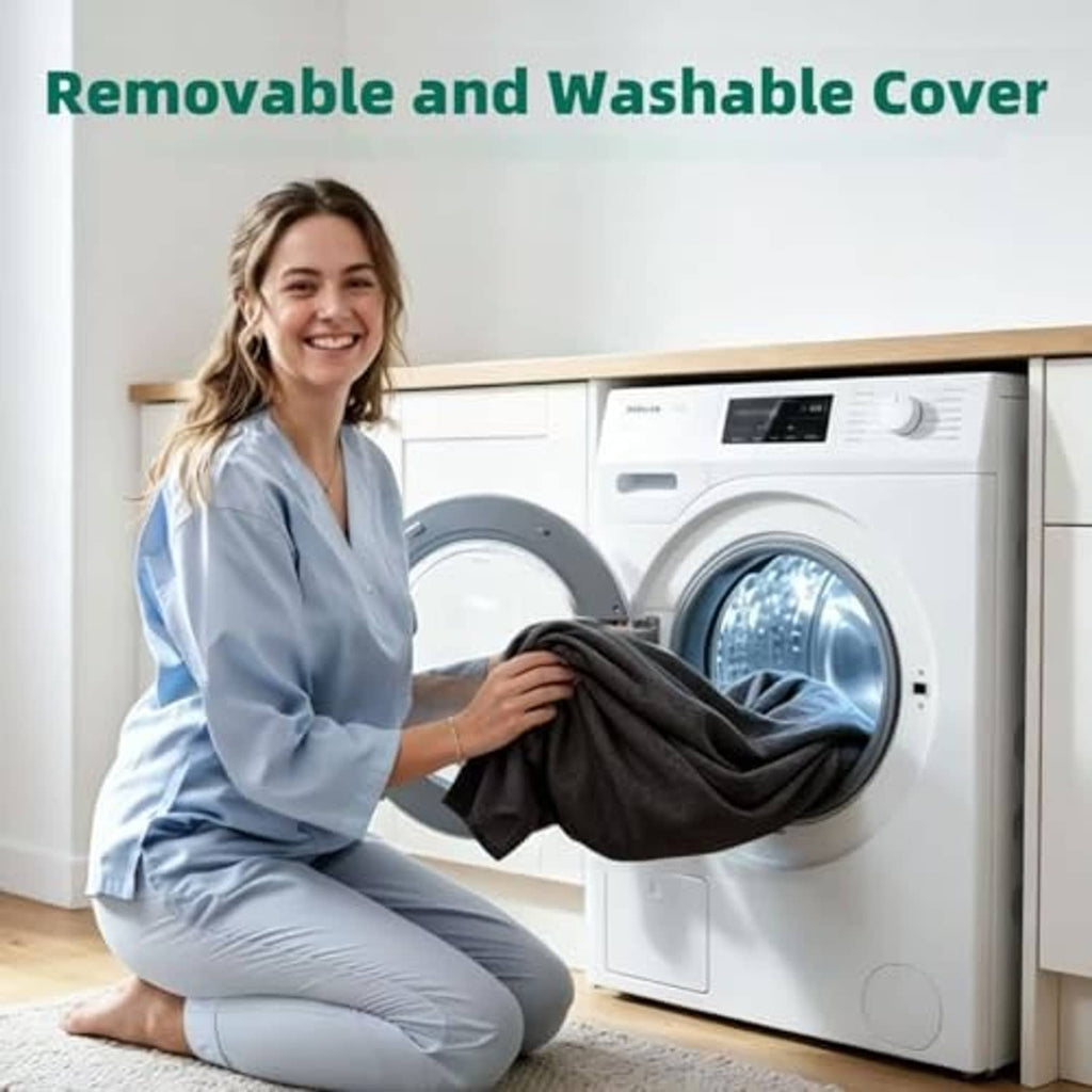 Black removable massage table topper cover being handled for washing