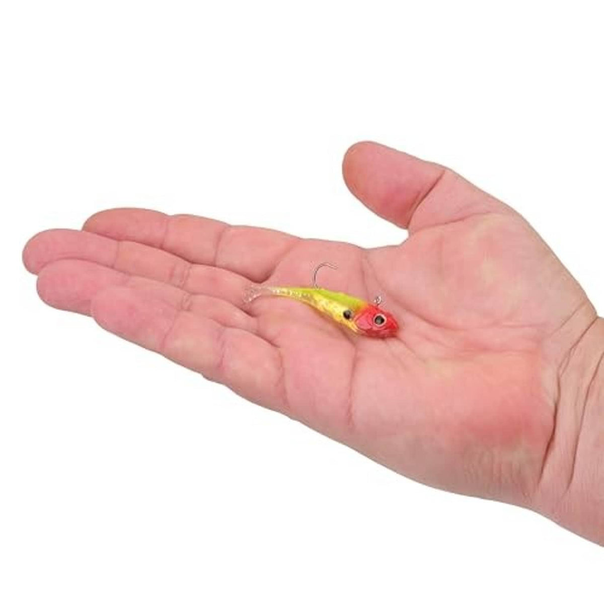 Soft plastic fishing bait in hand, red head and yellow body with treble hook