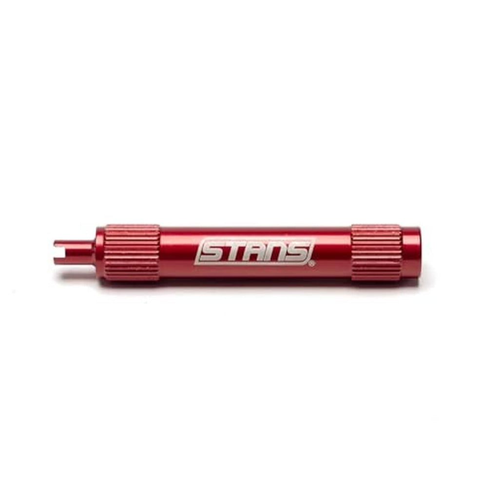 Red STANS tubeless core remover tool, side view with ribbed knurled grip sleeves