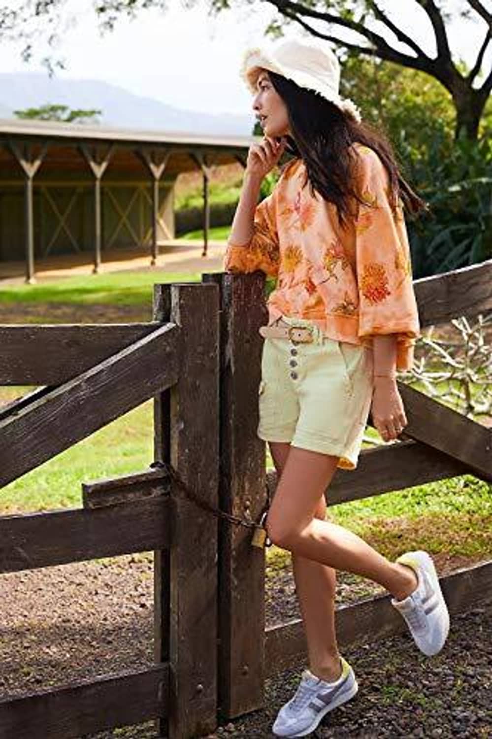 Cream bucket hat on woman with wide brim and frayed fringe trim