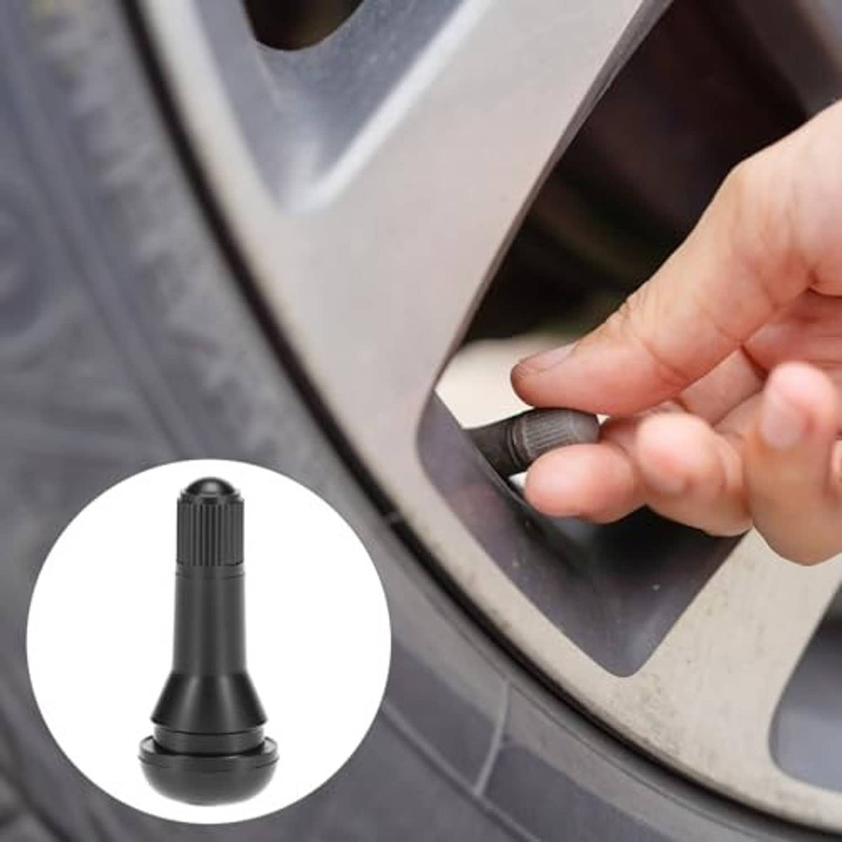 Close-up of snap-in tire valve stem being pushed into a wheel opening