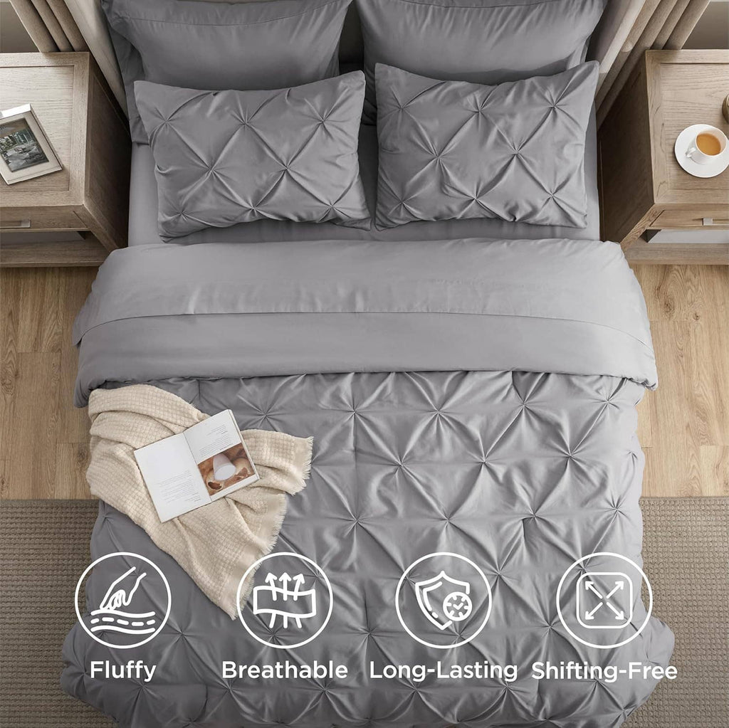 Grey queen comforter set with pinch-pleat quilted pillows and coordinated bedding