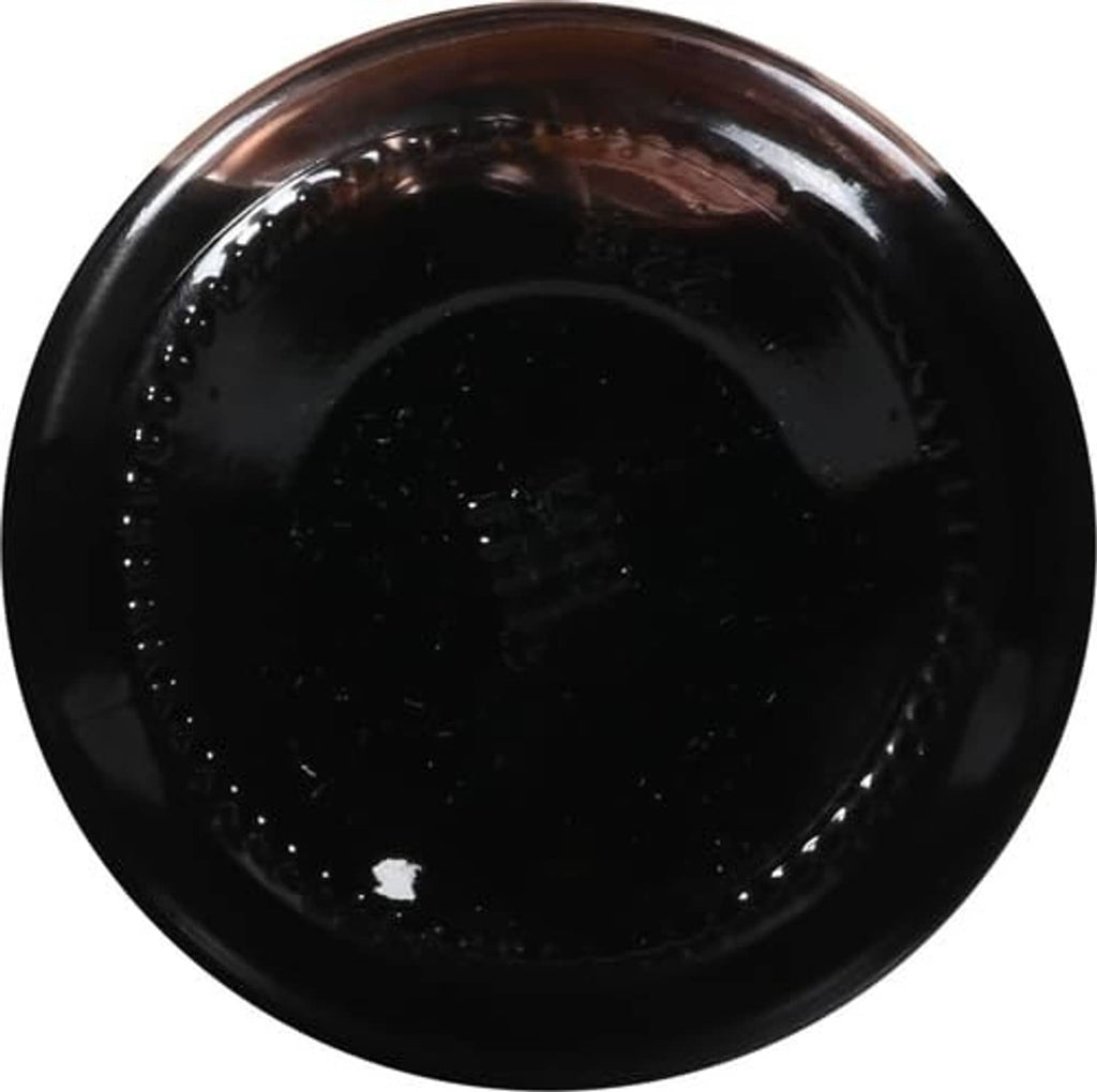 Dark red maraschino cherry syrup in a glossy jar, top-down view.
