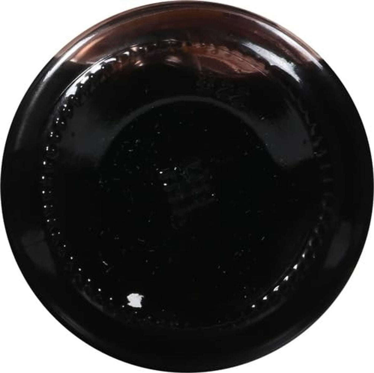 Dark red maraschino cherry syrup in a glossy jar, top-down view.