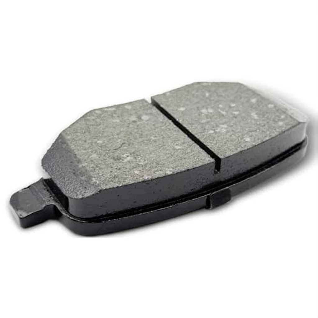 Ceramic brake pad with gray speckled friction surface and black backing, close angled view