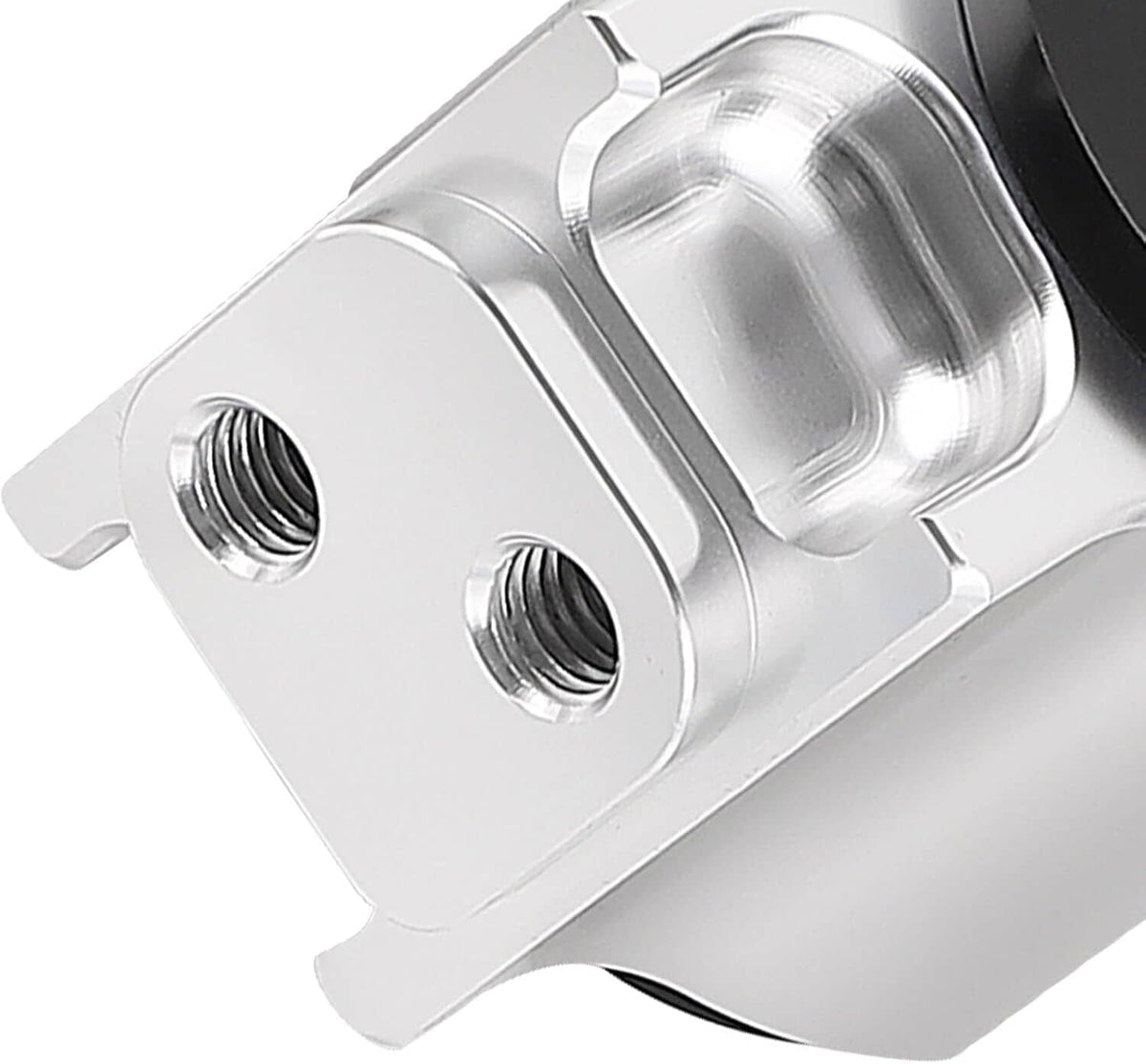 Close-up silver motor mount bracket with two threaded holes and smooth machined finish