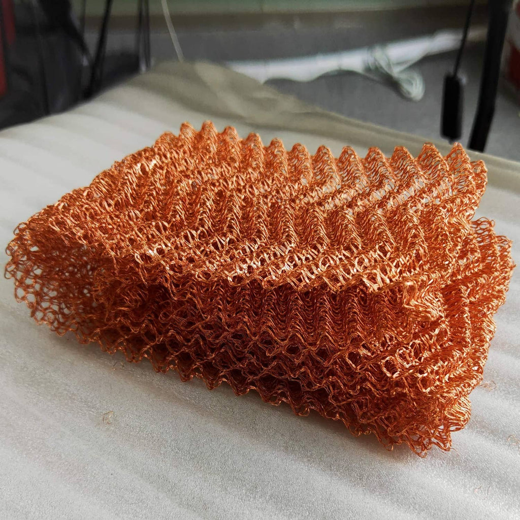 Copper mesh roll with curly copper wire net texture, laid flat for coverage