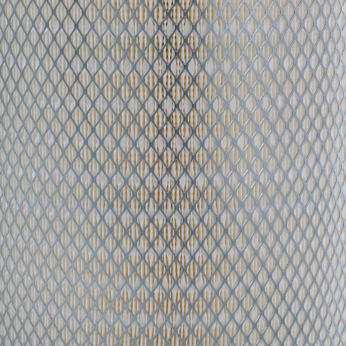 Close-up of pleated engine air filter mesh showing fine grid pattern