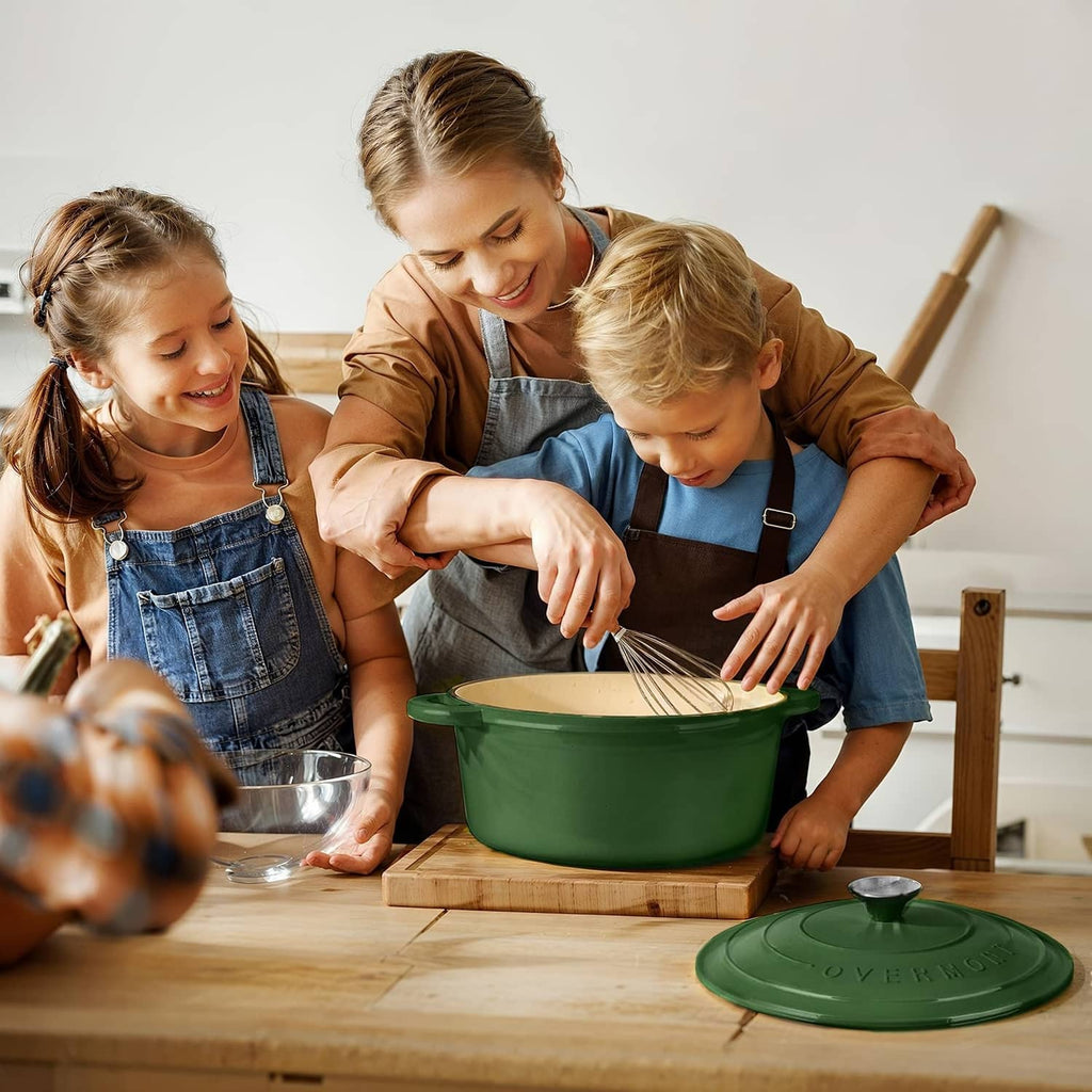 Green enameled Dutch oven on table with lid beside, family cooking together