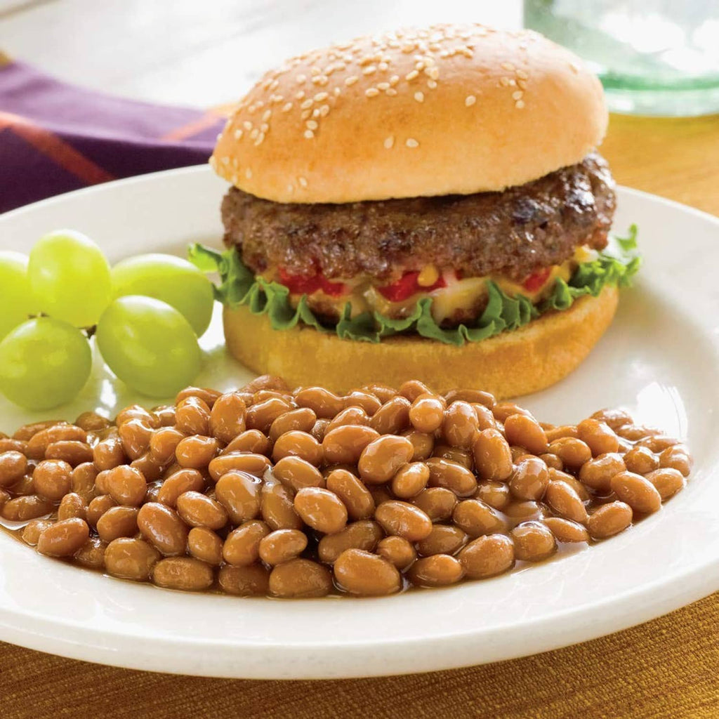 Bowl of baked beans with a hamburger on a plate