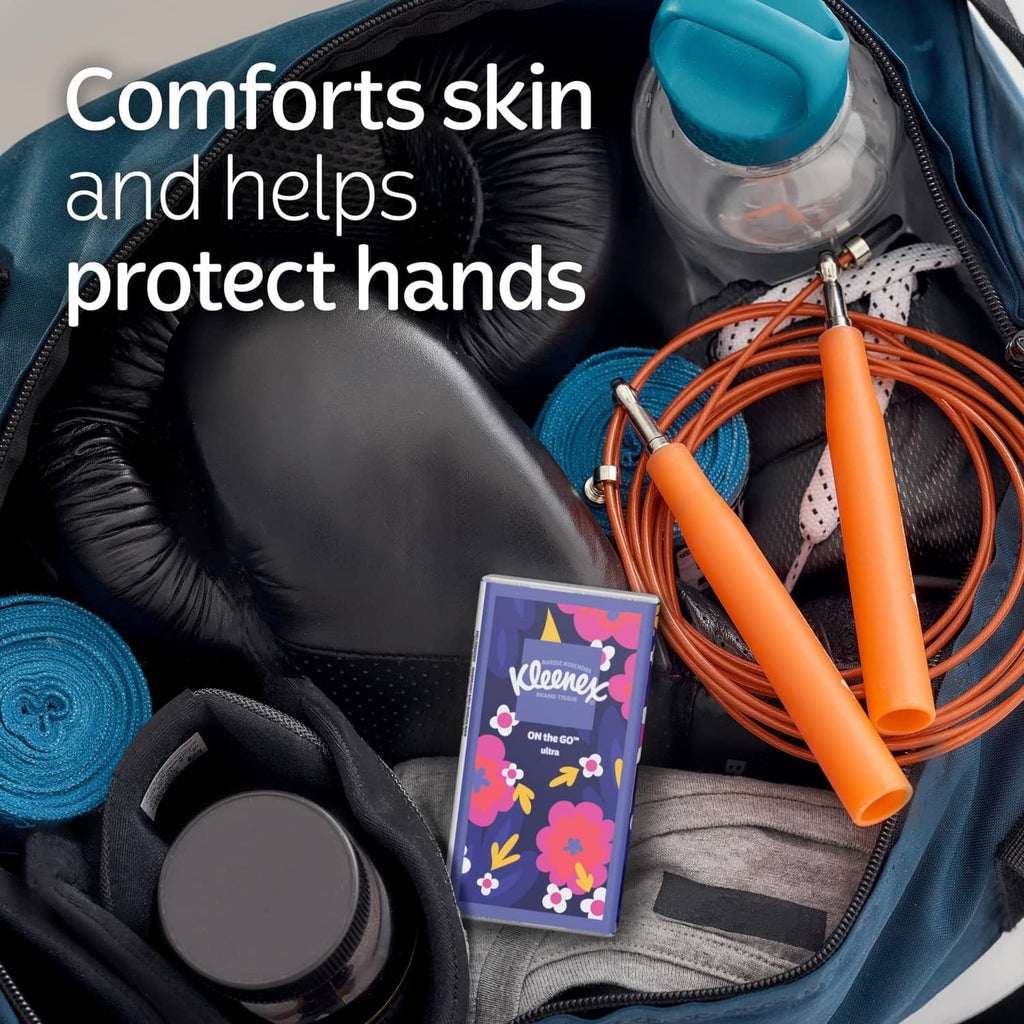 Kleenex On-the-go pocket tissue pack beside travel bag items