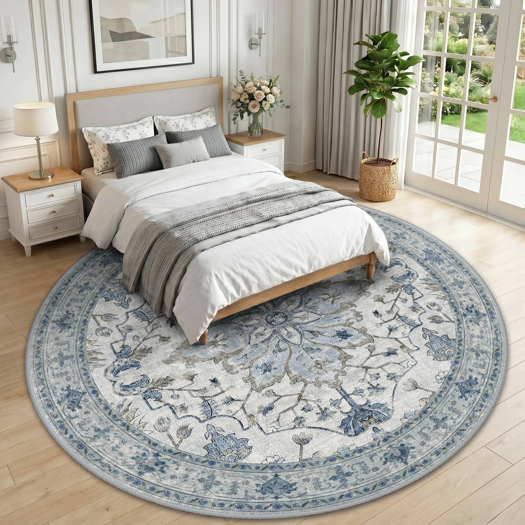 Round area rug with blue border and gray floral motifs, laid on hardwood floor