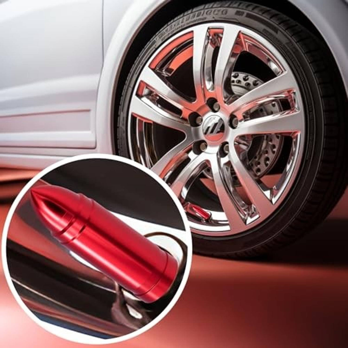 Red bullet valve stem cap fitted near a chrome wheel on a vehicle