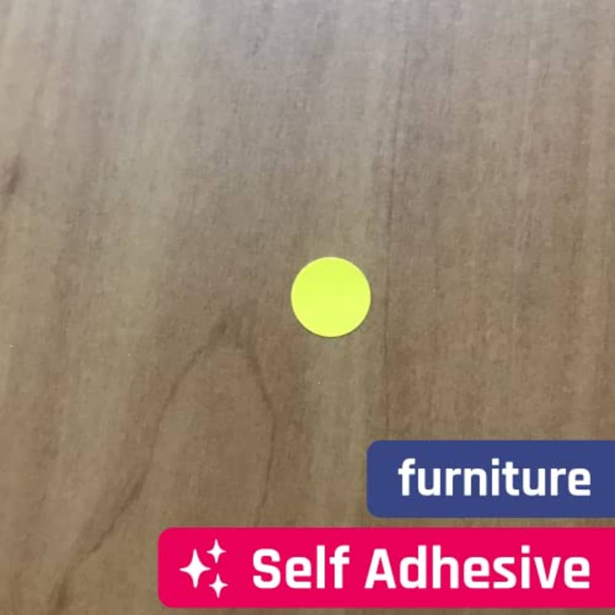 Self-adhesive yellow round dot sticker on a cardboard surface