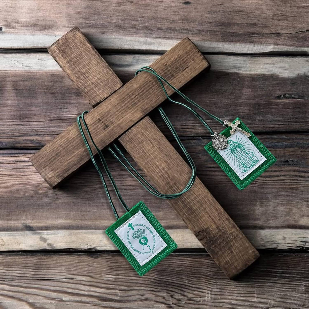 Green scapular trio with white panels and metal medals on braided green cords