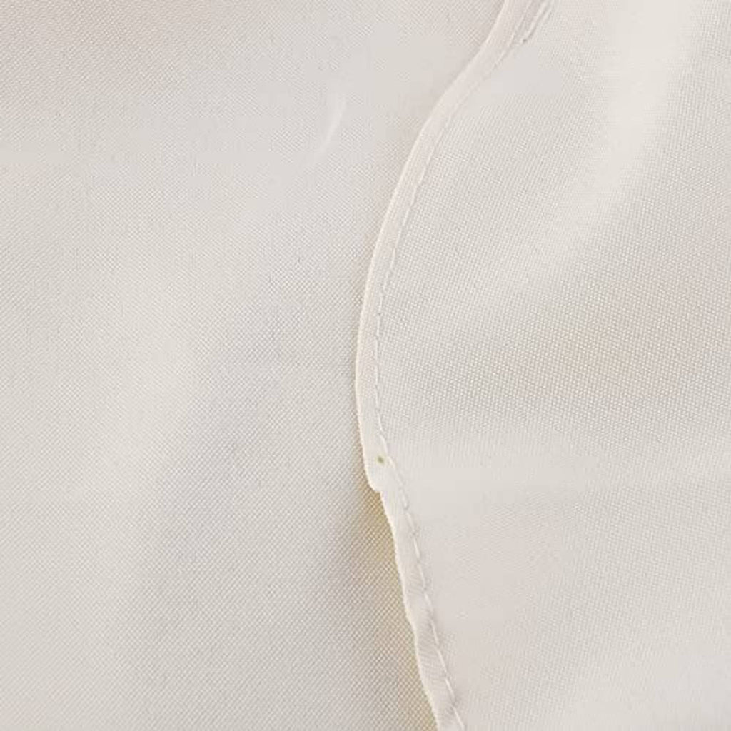 Close-up of light cream umbrella canopy fabric with stitched seam along the edge