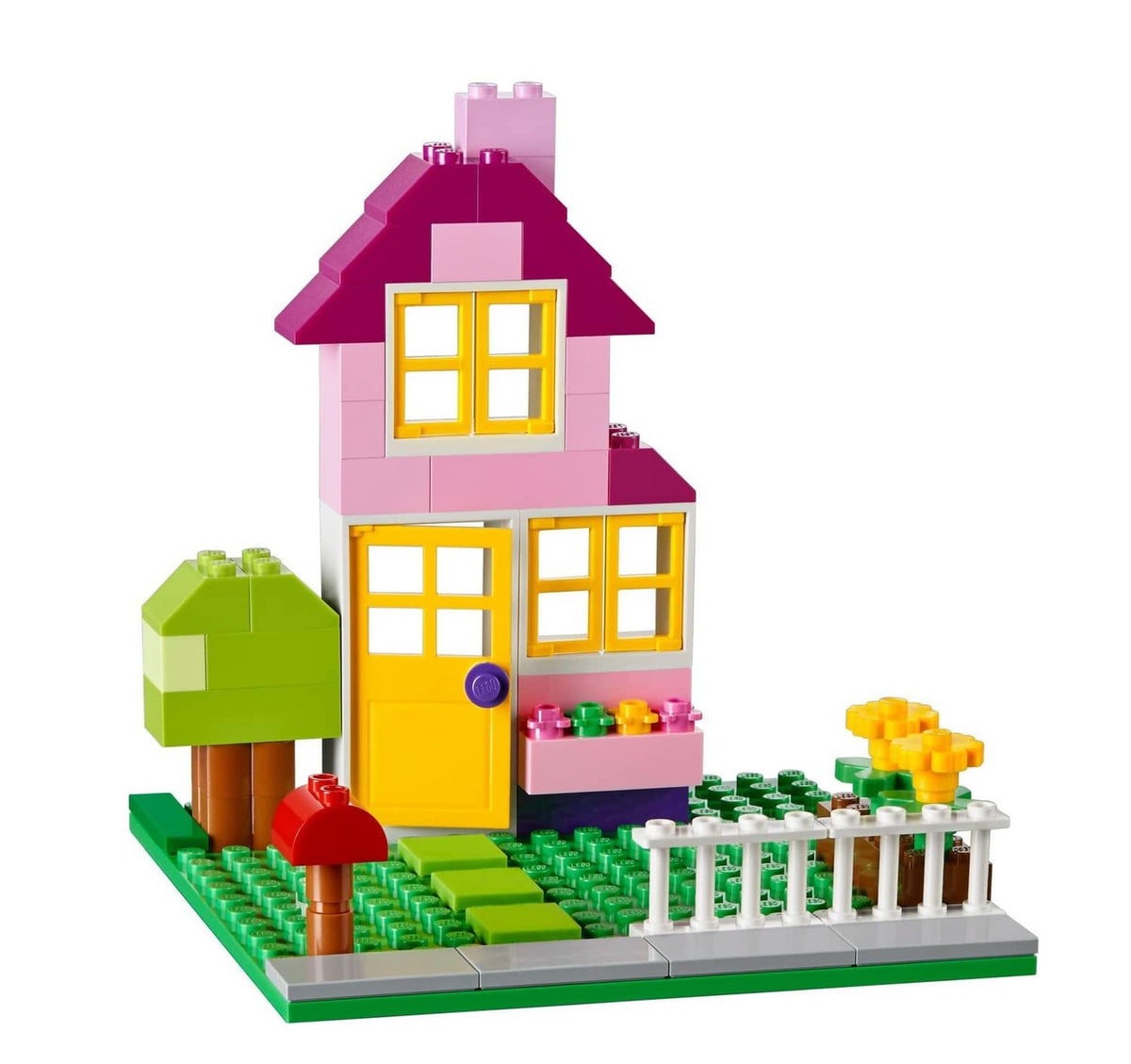 Pink two-story LEGO house model with yellow windows and green garden base