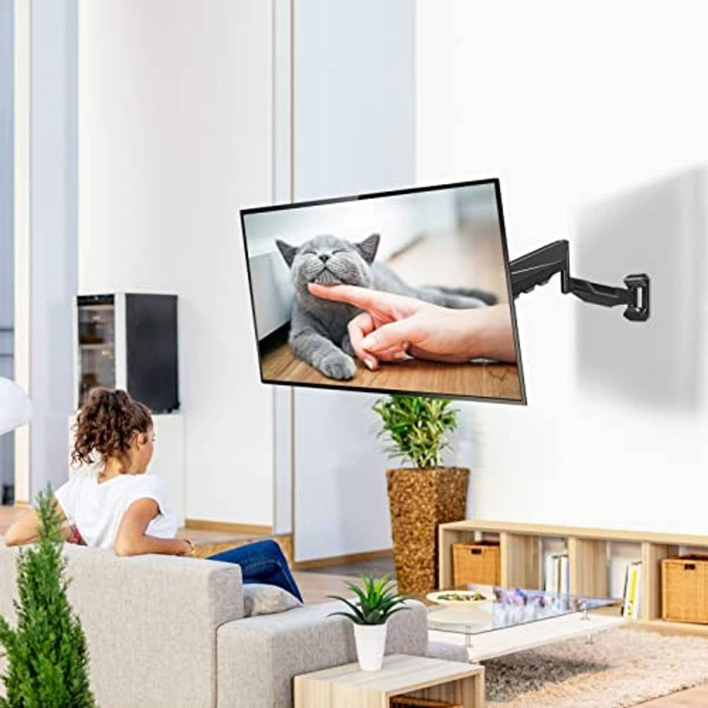 Height-adjustable TV wall mount installed with a flat-screen TV on the wall