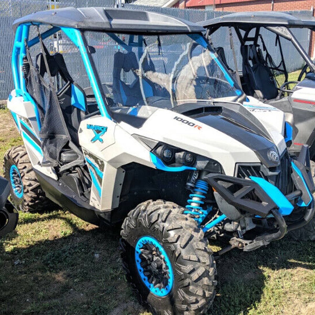 Clear windshield windscreen with black supports on side of UTV cab