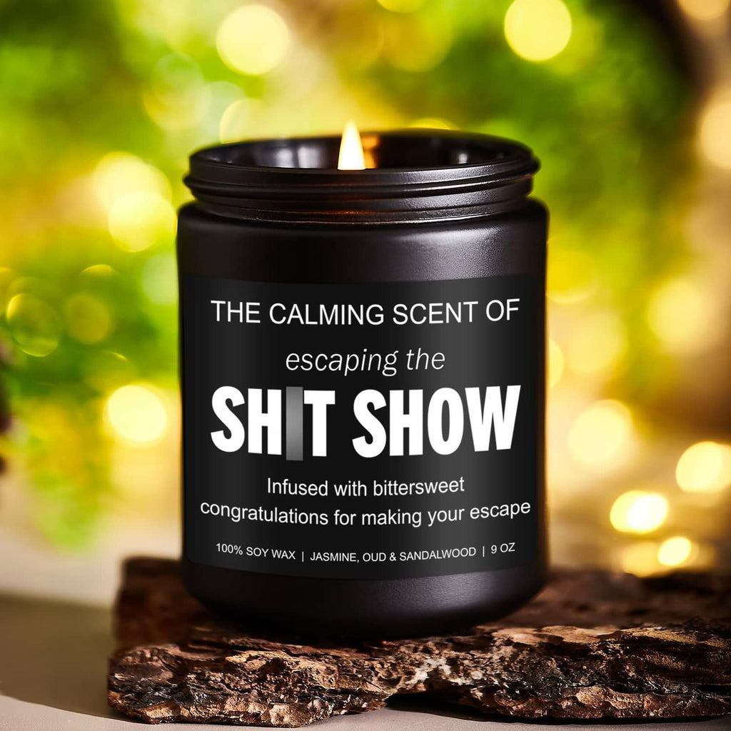 Black jar candle with lit wick and bold white label; soy wax candle, 9 oz.