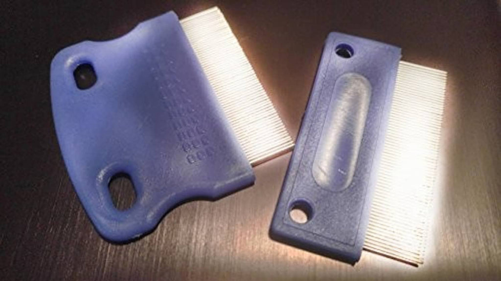 Blue handled tear-stain remover combs with fine white bristles and cut-out holes