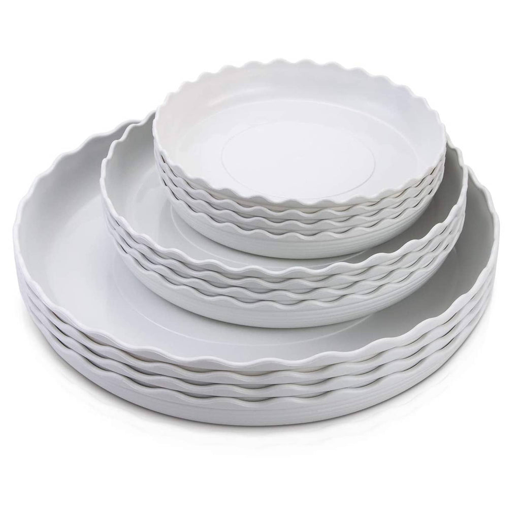 Stacked white round plastic plates with wavy scalloped edges