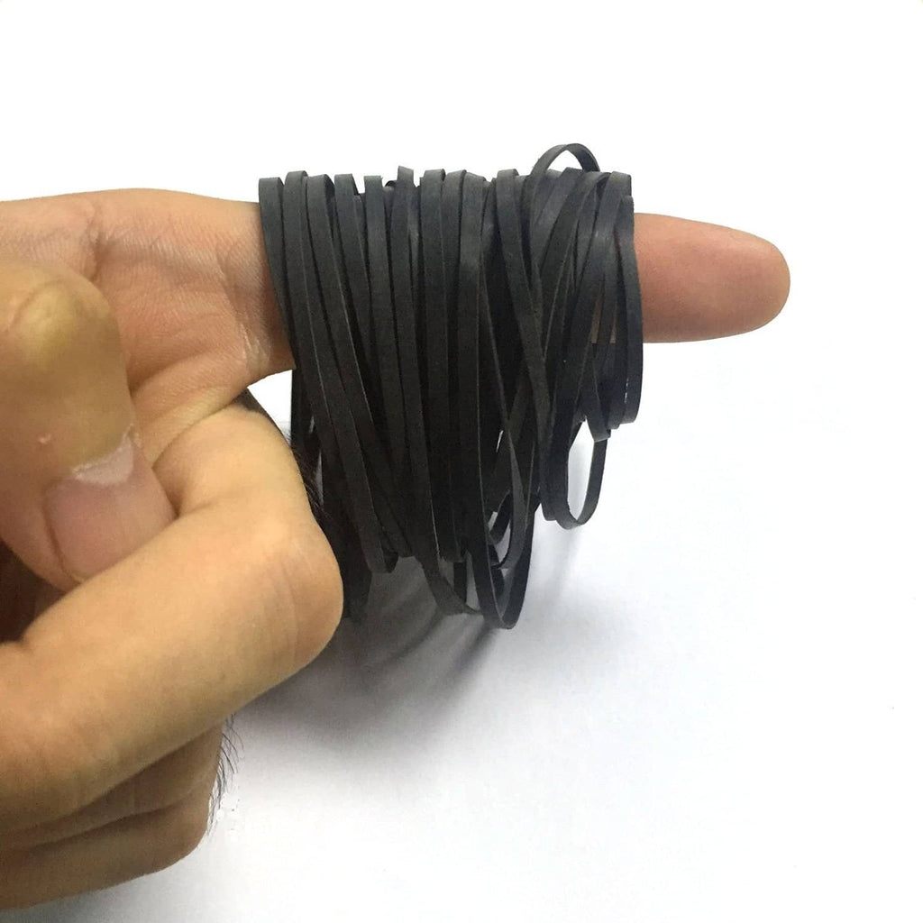 Black rubber flat belt strips, shown by hand, looped for cassette use