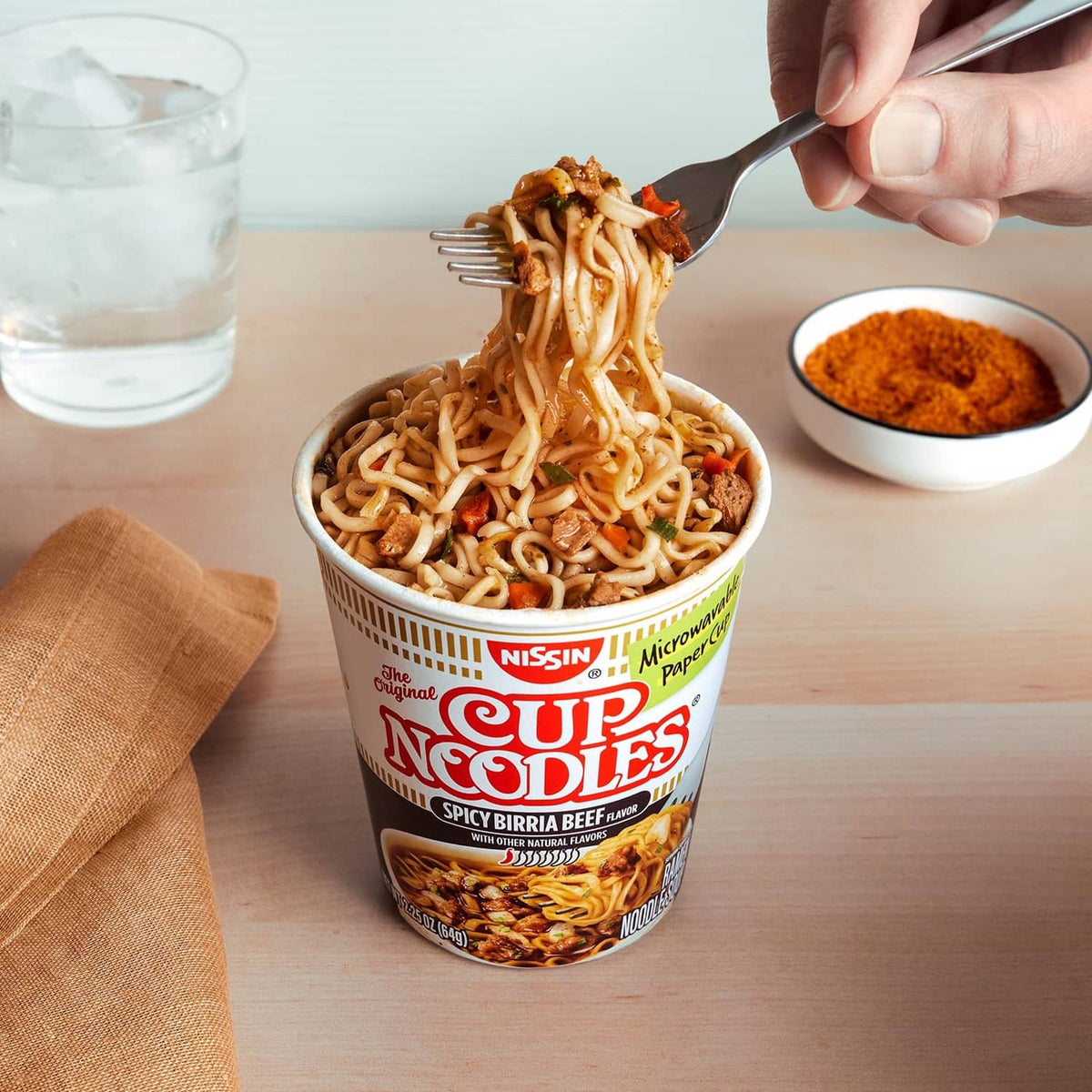 Spicy birria beef Cup Noodles cup with forkful noodles over the open cup