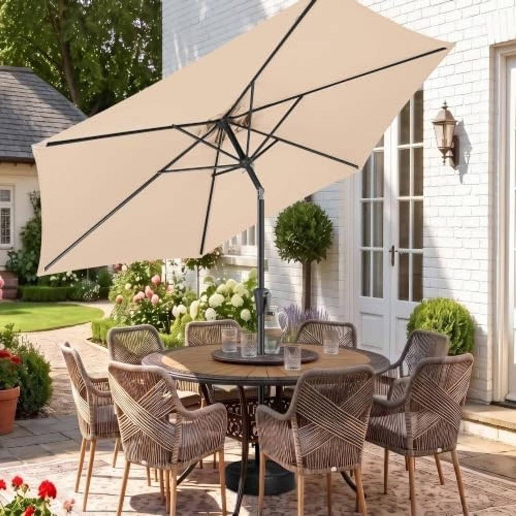 Beige patio umbrella open over outdoor seating