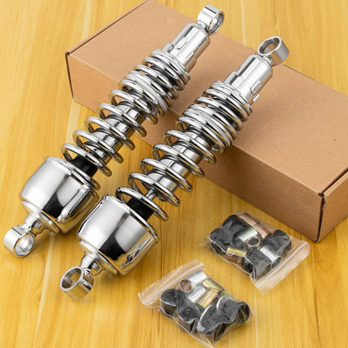 Pair of chrome 13-inch rear shocks in a box set with small hardware bags
