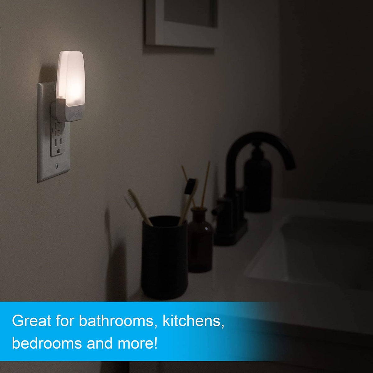 Plug-in LED night light on wall outlet with warm white glow near sink
