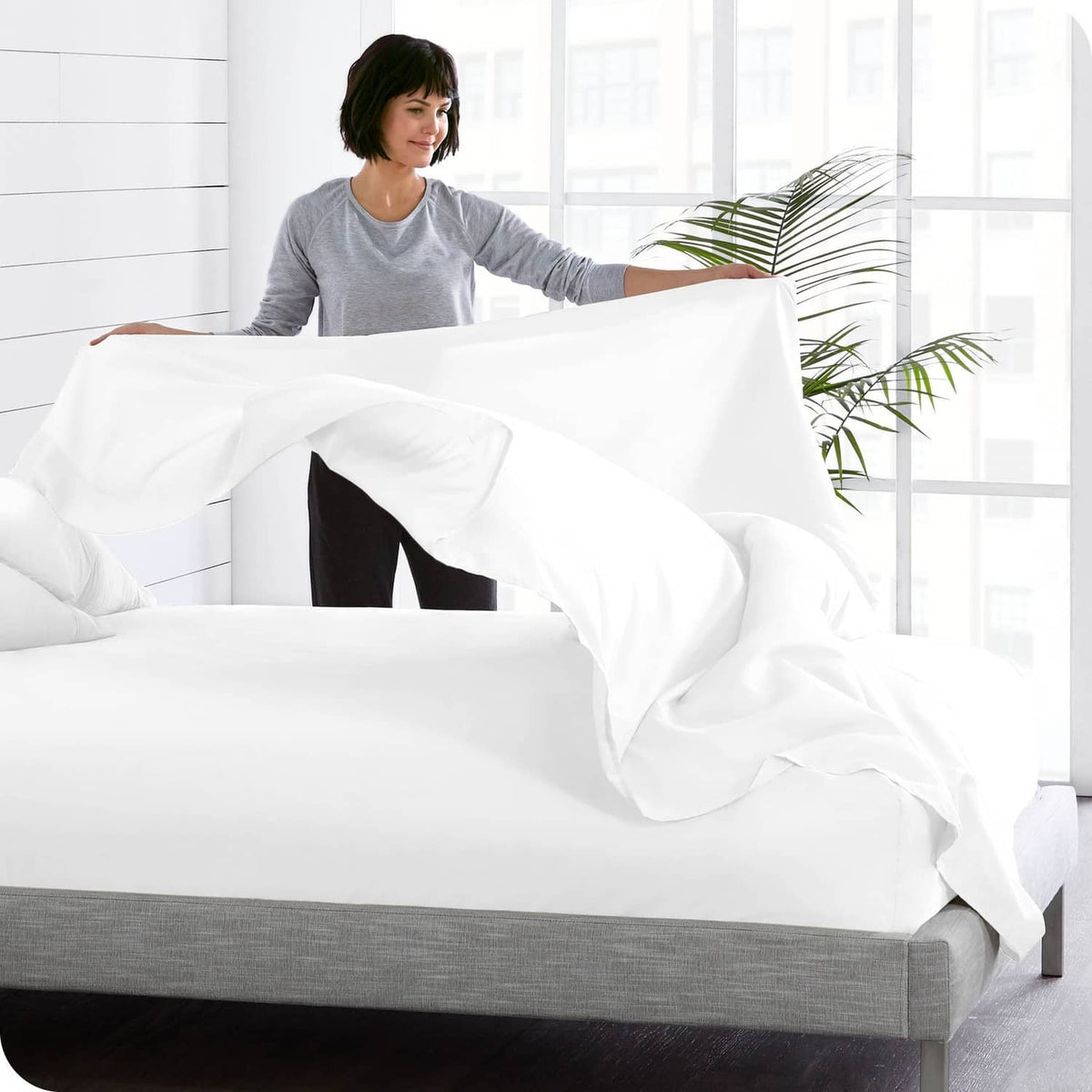 White twin flat sheet draped on a bed with soft, wrinkle-finished microfiber texture