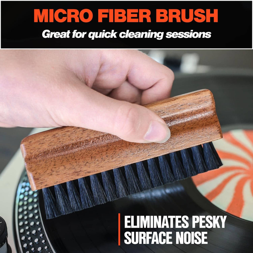 Micro fiber brush with wooden handle and blue bristles, held for quick cleaning