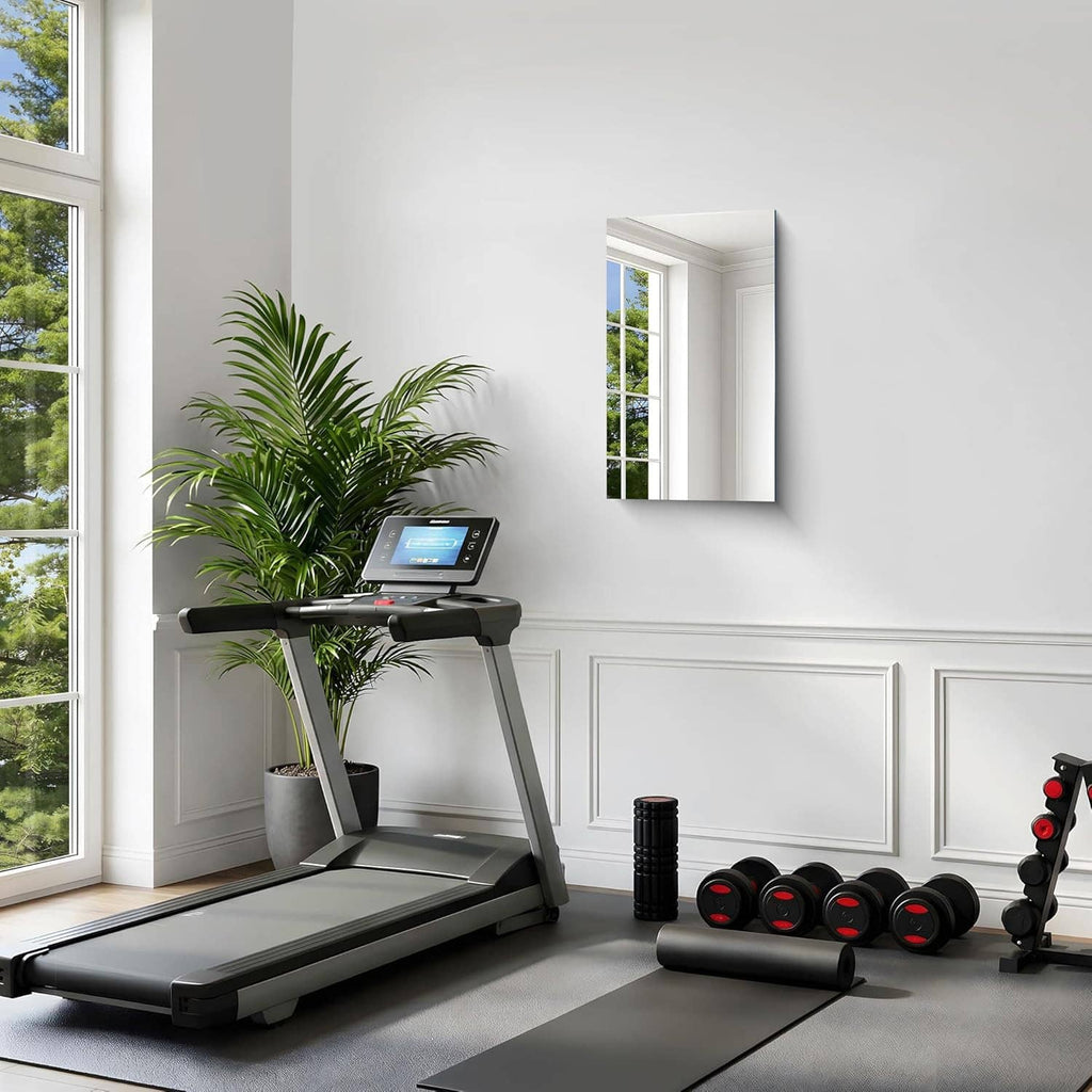 Rectangular frameless mirror mounted on wall with clear reflective surface