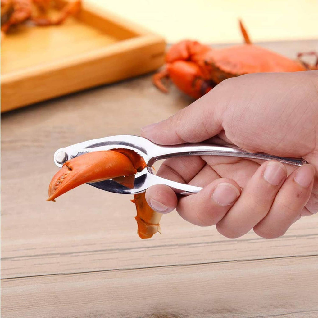 Hand using stainless steel crab cracker to split an orange shellfish