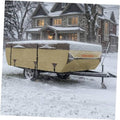Tan folding tent trailer cover, fully draped over trailer with front flap closed in snow.