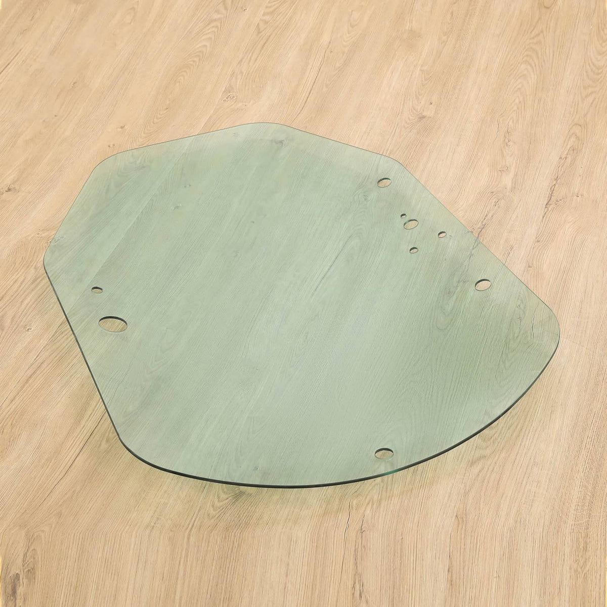 Green cab door glass panel with mounting holes and curved lower edge