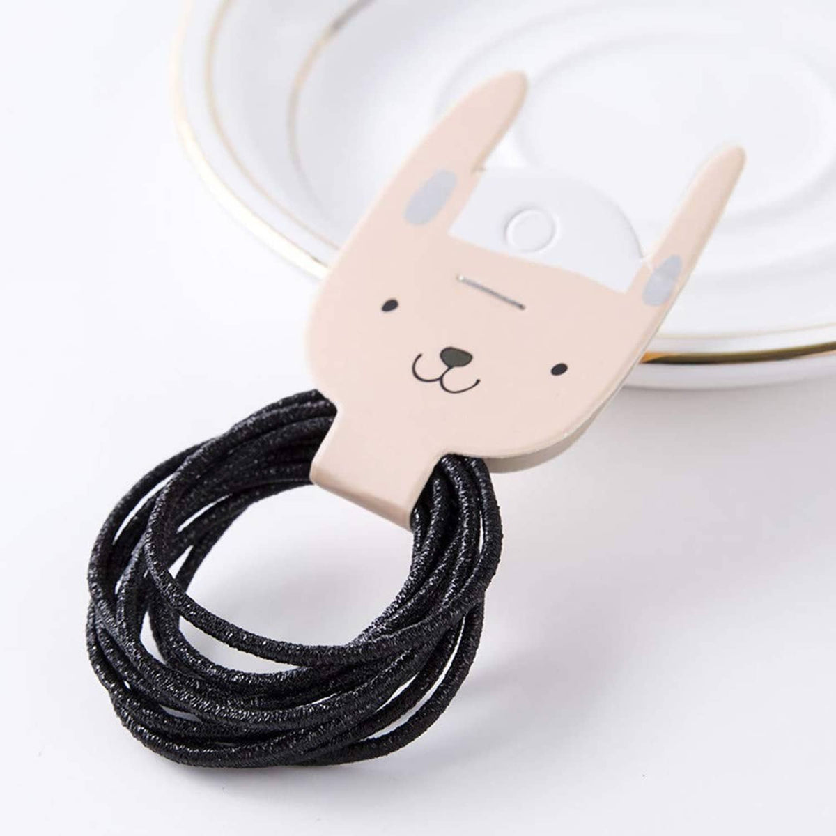 Black glitter hair elastic loop on bunny-shaped holder