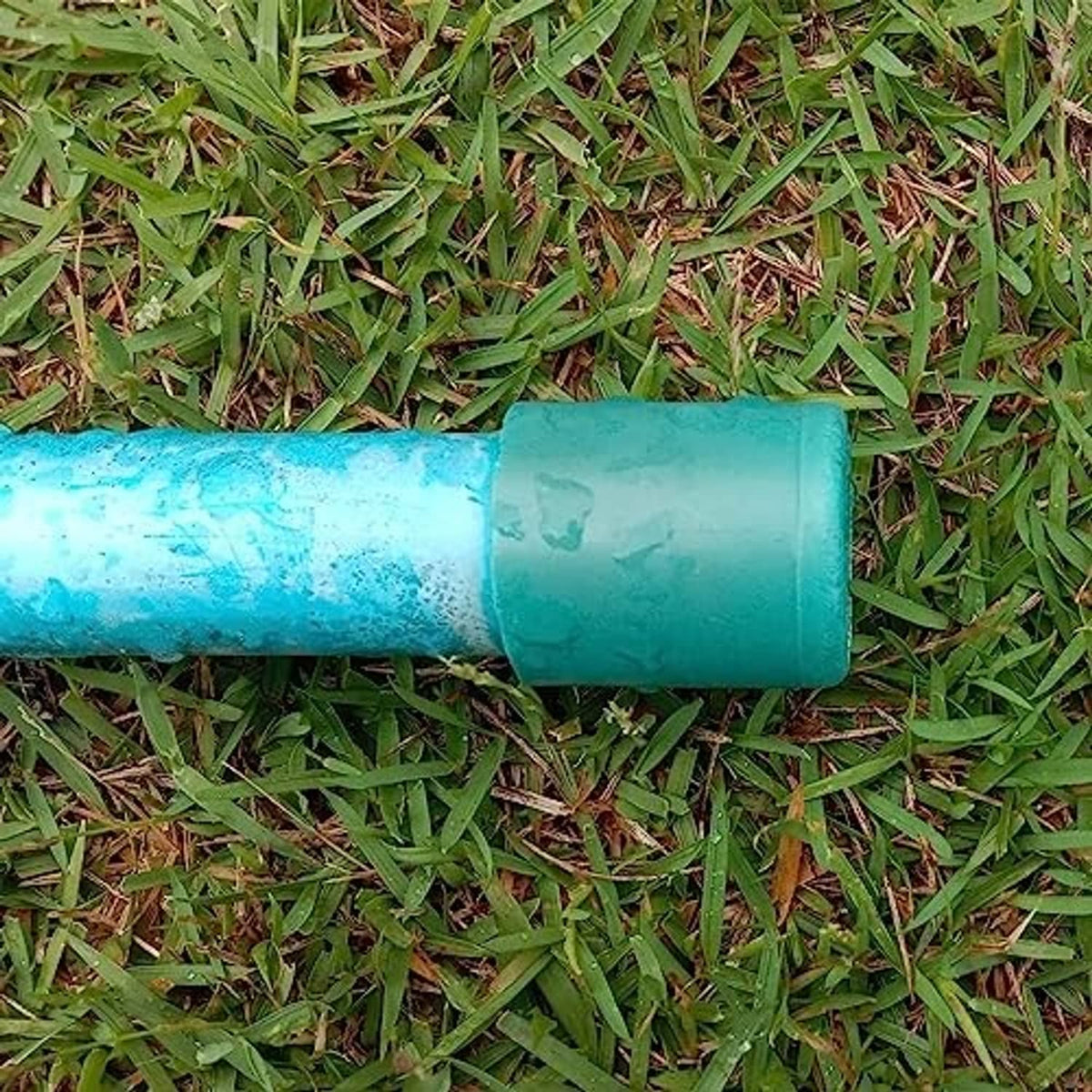 White PVC pipe end cap plug installed on a pipe end