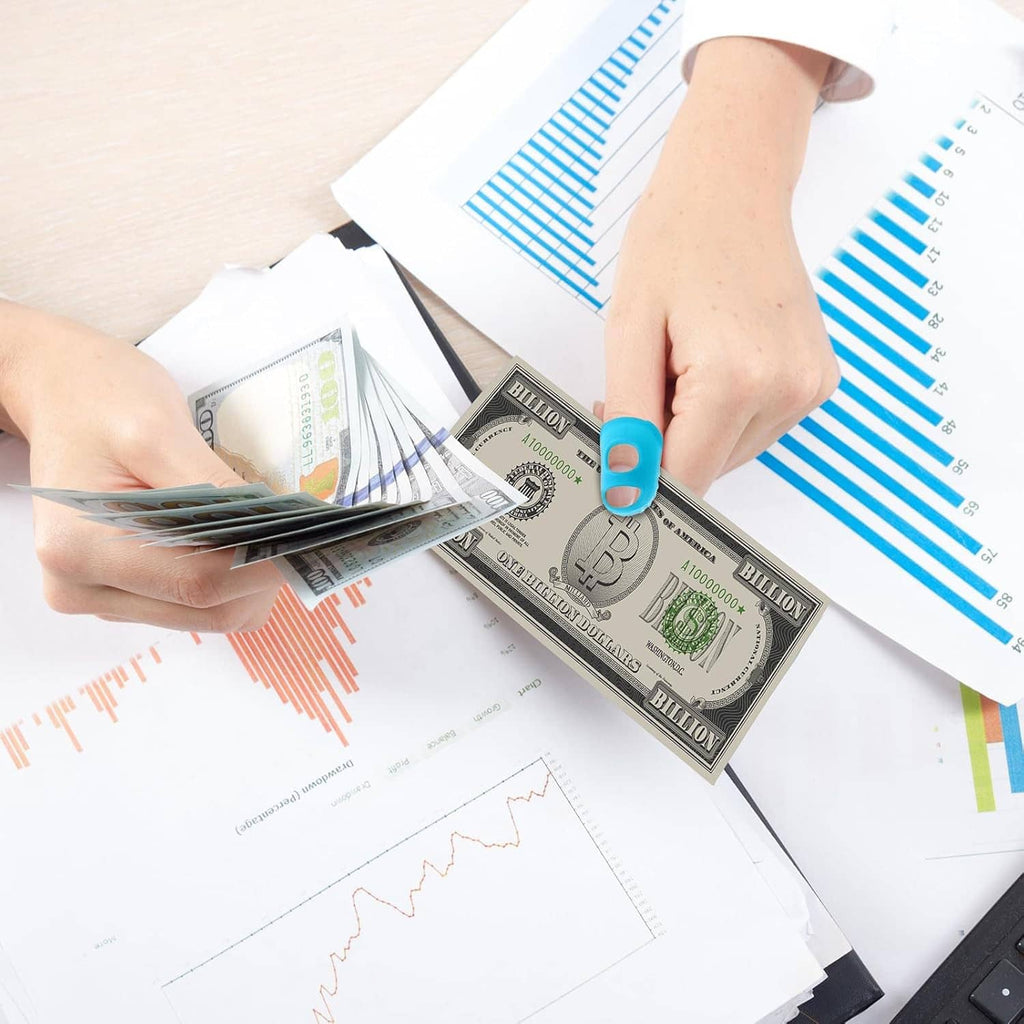 Finger protector caps on fingers while holding cash and charts
