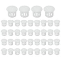 Set of white round plastic flush hole plugs arranged in rows