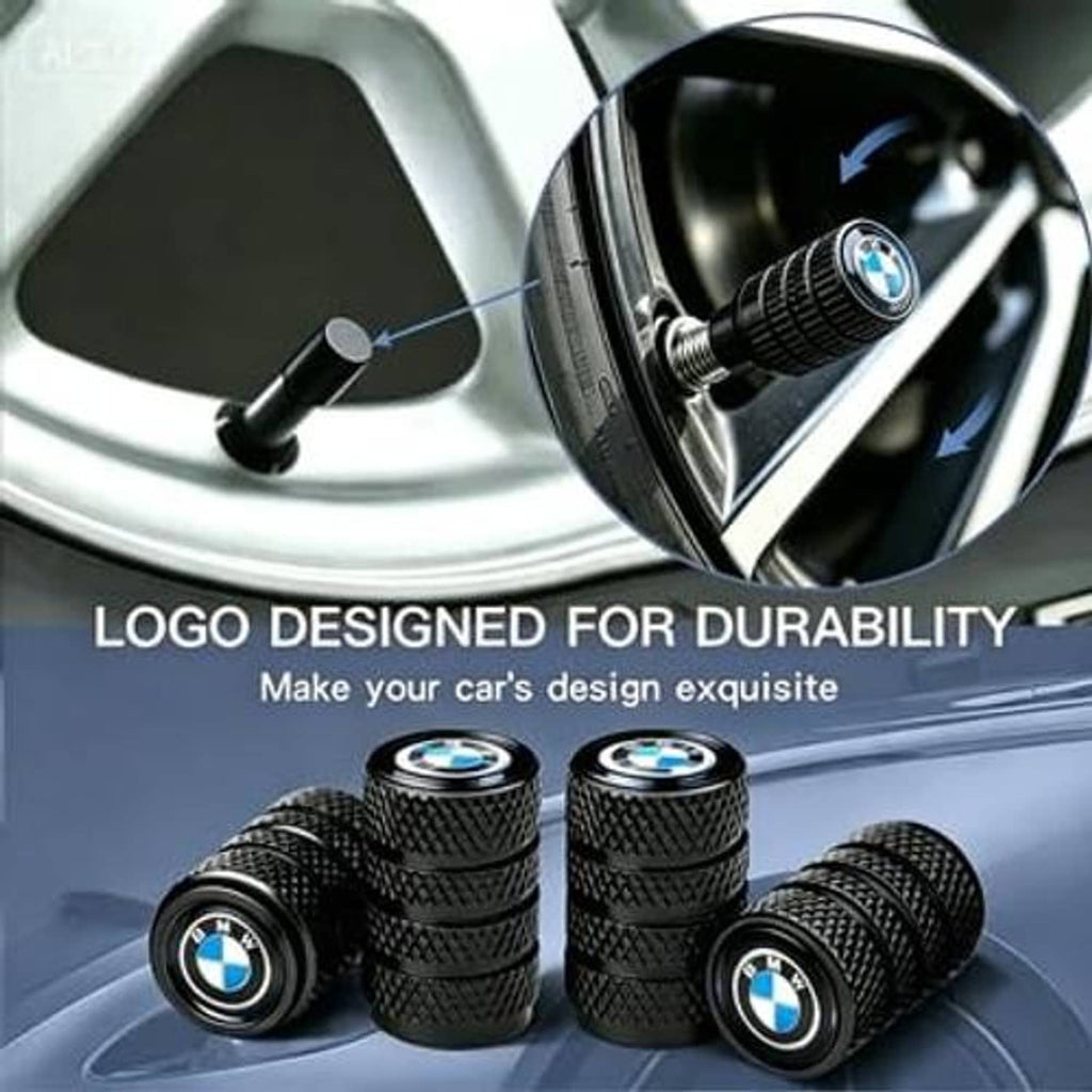 Set of black tire valve stem caps with textured grip and BMW logo near wheel