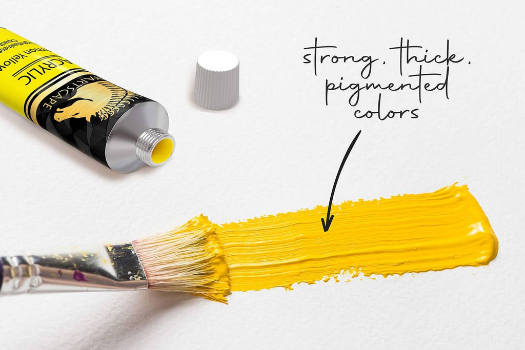 Acrylic paint tube squeezing bright yellow paint with brush tip